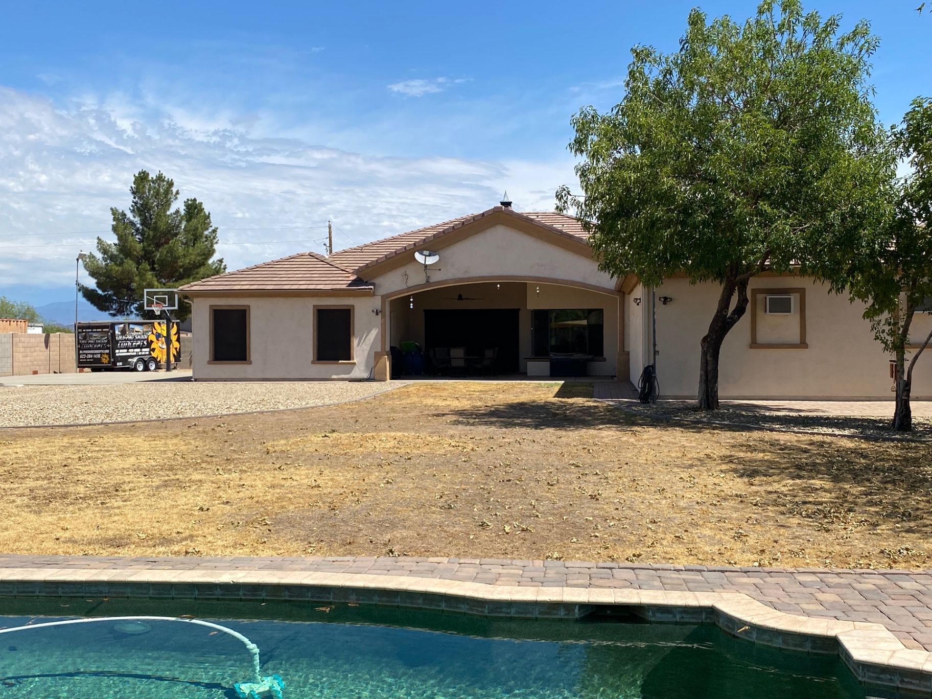 Aurora Estate — back yard before, with dead lawn and tired kidney pool