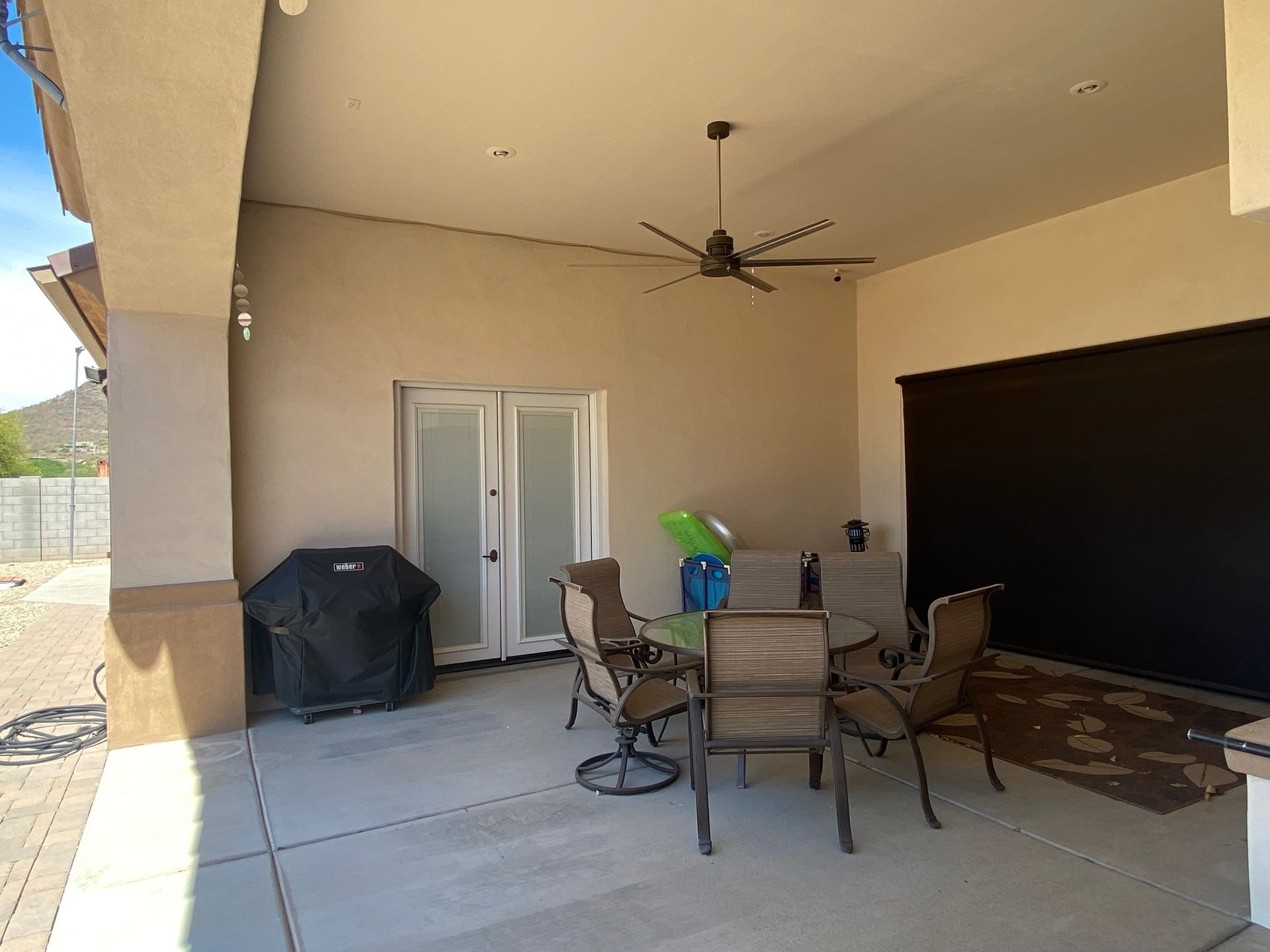 Aurora Estate — bare covered patio before outdoor kitchen, fire feature and TV install