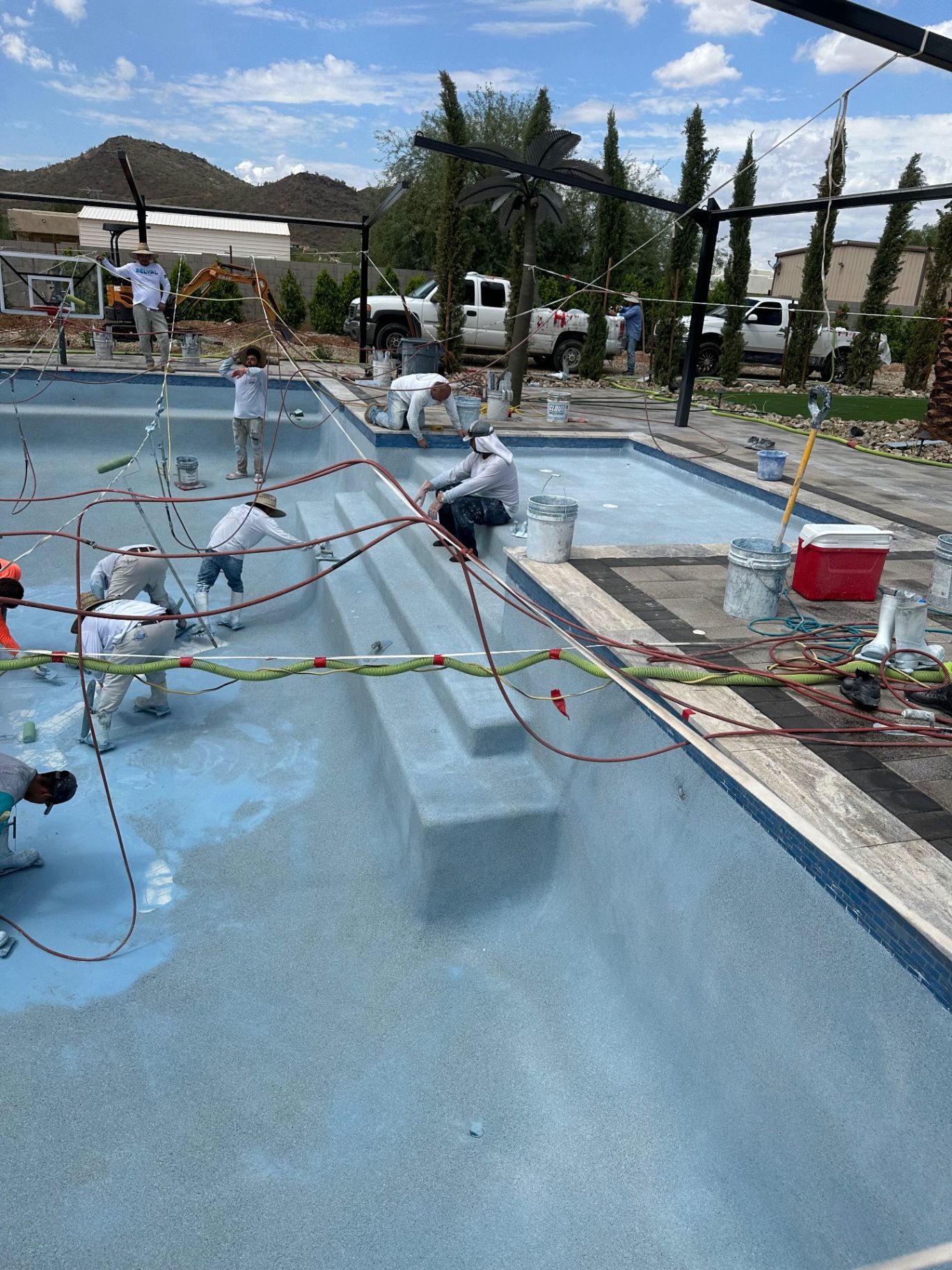 Aurora Estate — pebble finish applied around the pool steps, tanning ledge and raised spa wall during interior install